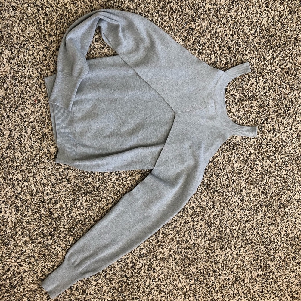Gray long sleeve open shoulder winged sweater.